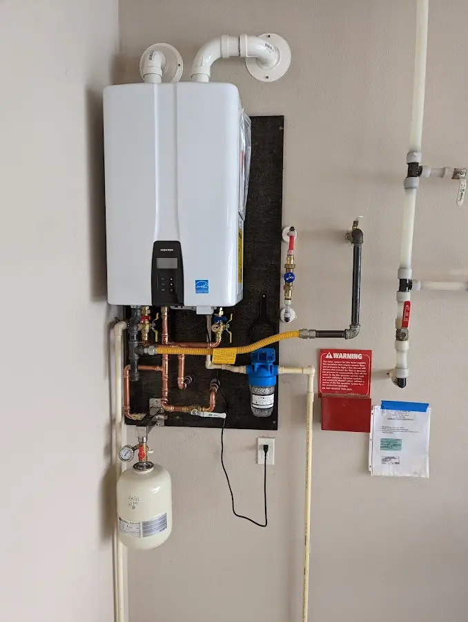 Professional plumber installing copper piping in a Perry Heights home